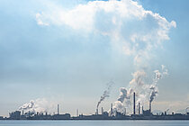 Smoking factory chimneys on a seashore
